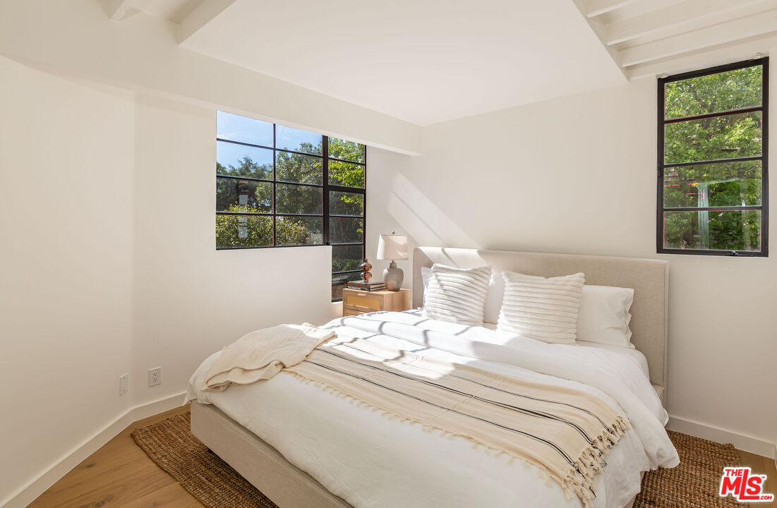 29233 Heathercliff Road, Unit 2 Malibu, CA 90265 - Photo 15 of 20 a bedroom with a bed and a window