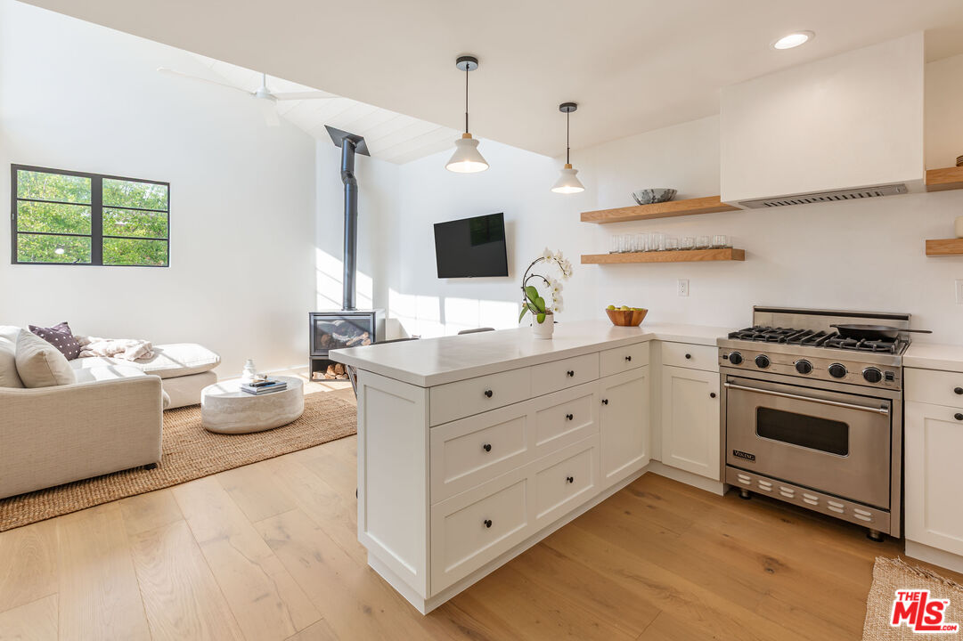 29233 Heathercliff Road, Unit 2 Malibu, CA 90265 - Photo 10 of 20 a kitchen with stainless steel appliances white cabinets and stove