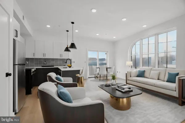 a living room with fireplace furniture and a large window