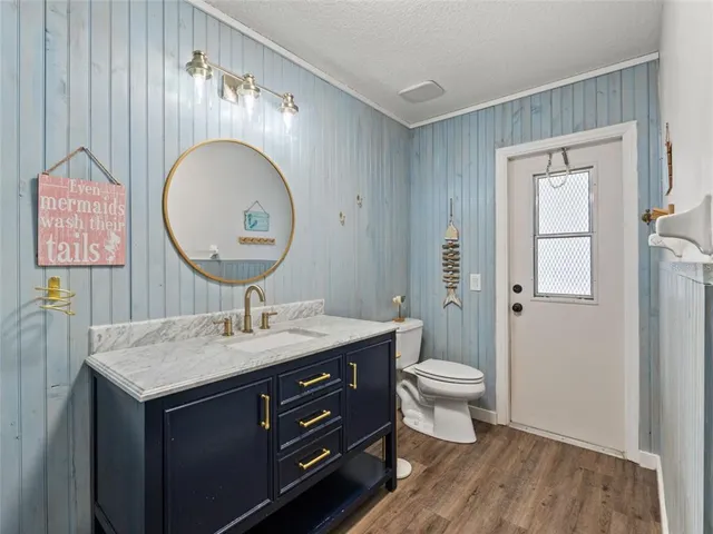 a bathroom with a toilet a sink and a mirror