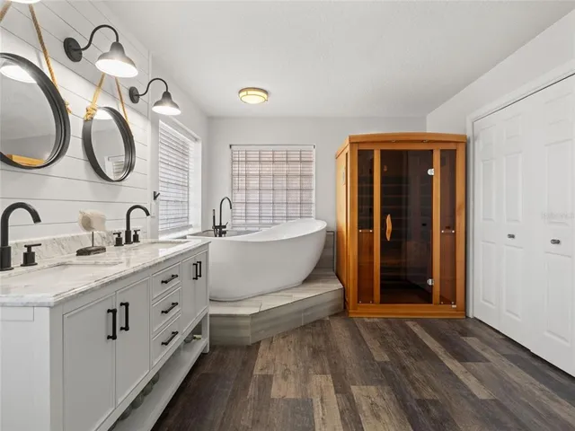 a bathroom with a double vanity sink and a mirror