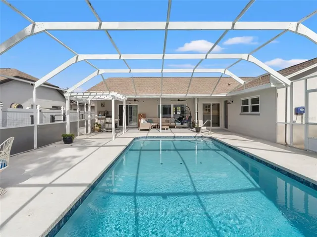 a view of a backyard with swimming pool