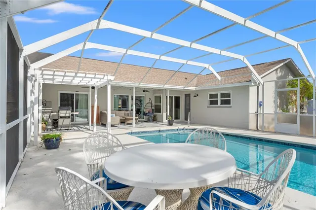 a view of a patio with table and chairs under an umbrella
