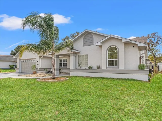 a view of a house with a yard and sitting area