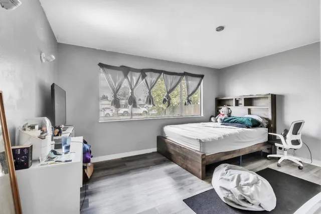 a bedroom with a bed and a window