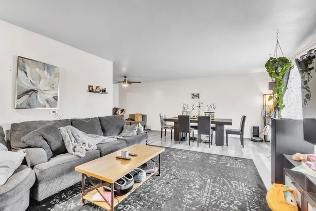 a living room with furniture and a chandelier