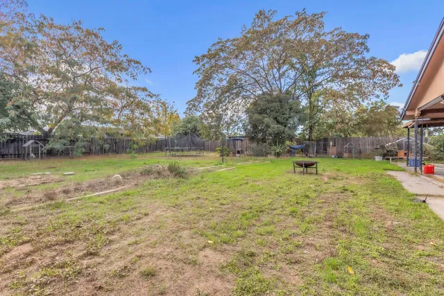 a view of yard with swimming pool and green space