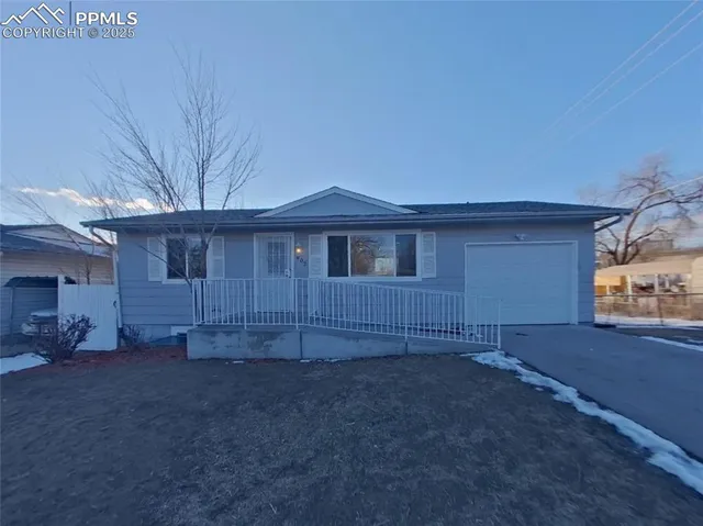 a view of a house with a backyard