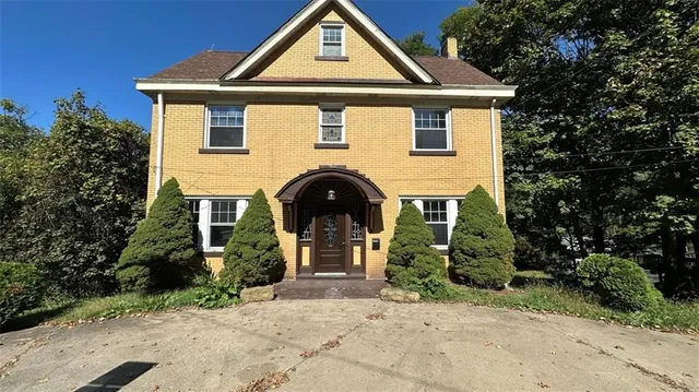 a front view of a house with garden