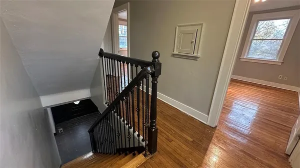 a view of entryway and hall with wooden floor