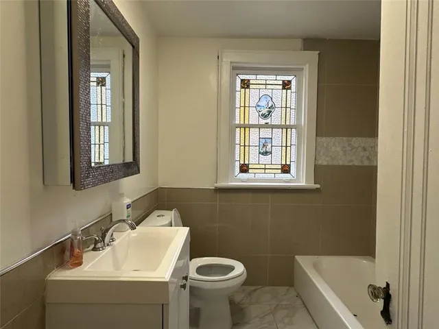 a bathroom with a sink a toilet and a bathtub
