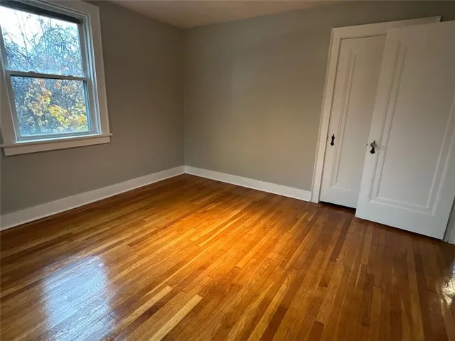 a view of room with window and wooden floor