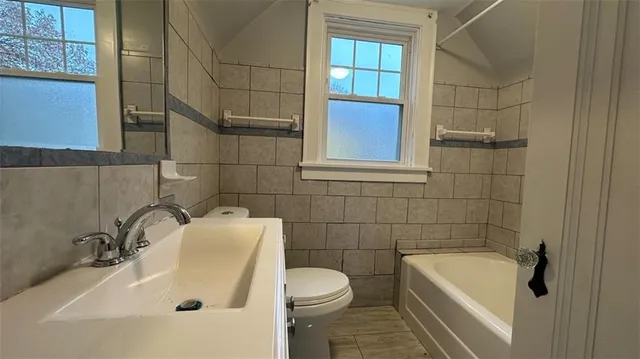 a bathroom with a sink a toilet and bathtub