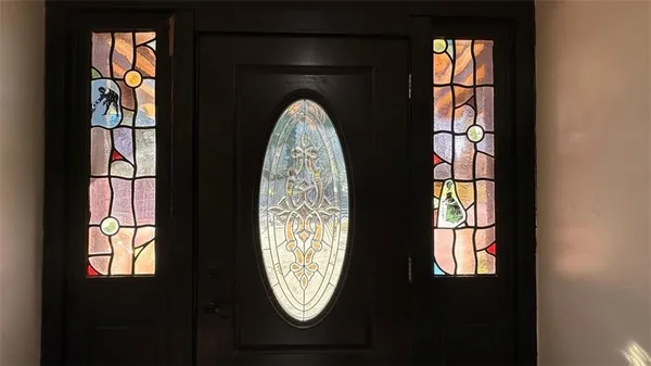 an empty room with windows and entrance