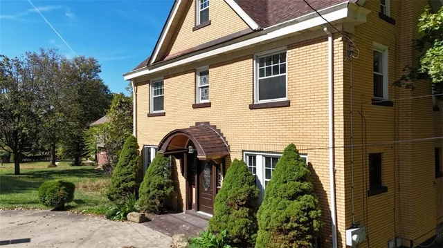 a front view of a house with garden