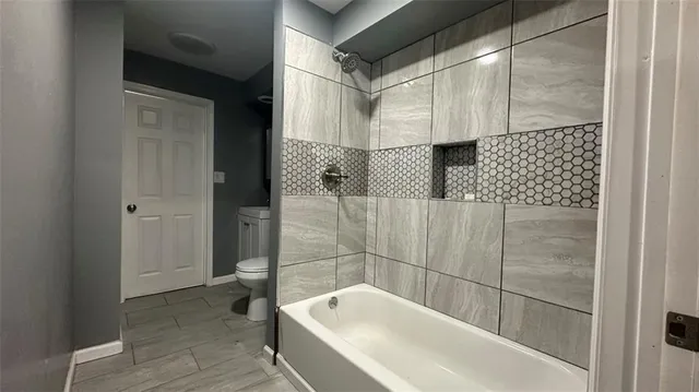 a bathroom with a bathtub and shower