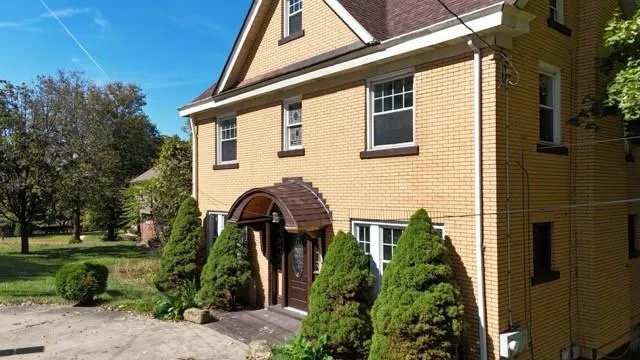 a front view of a house with garden