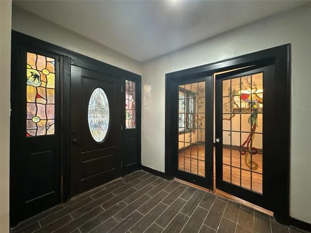 a view of a room with wooden floor