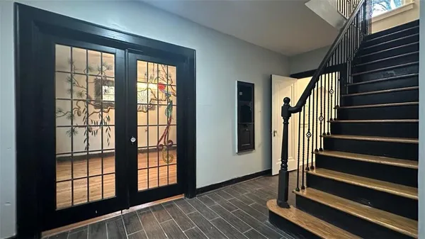 a view of an entryway with wooden floor and door