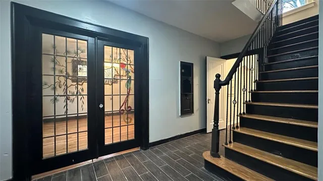 a view of an entryway with wooden floor and door