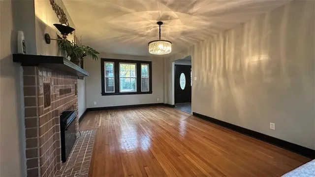 a view of a room with wooden floor and windows