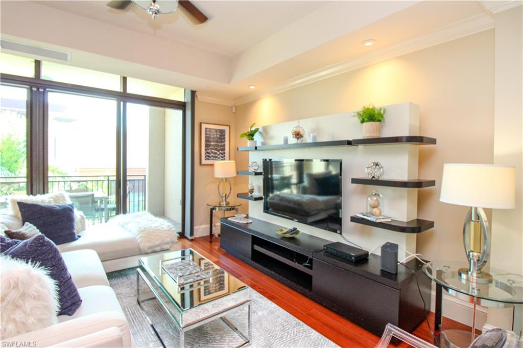9123 Strada Place, Unit 7410 Naples, FL 34108 - Photo 3 of 50 Living room with crown molding, ceiling fan, and hardwood / wood-style flooring