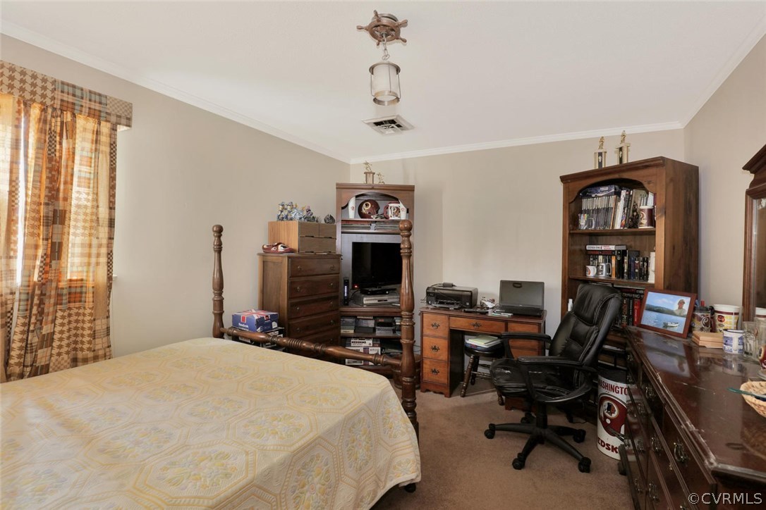 3300 Wood Dale Road Chester, VA 23831 - Photo 16 of 28 a bedroom with a bed a study table and large window