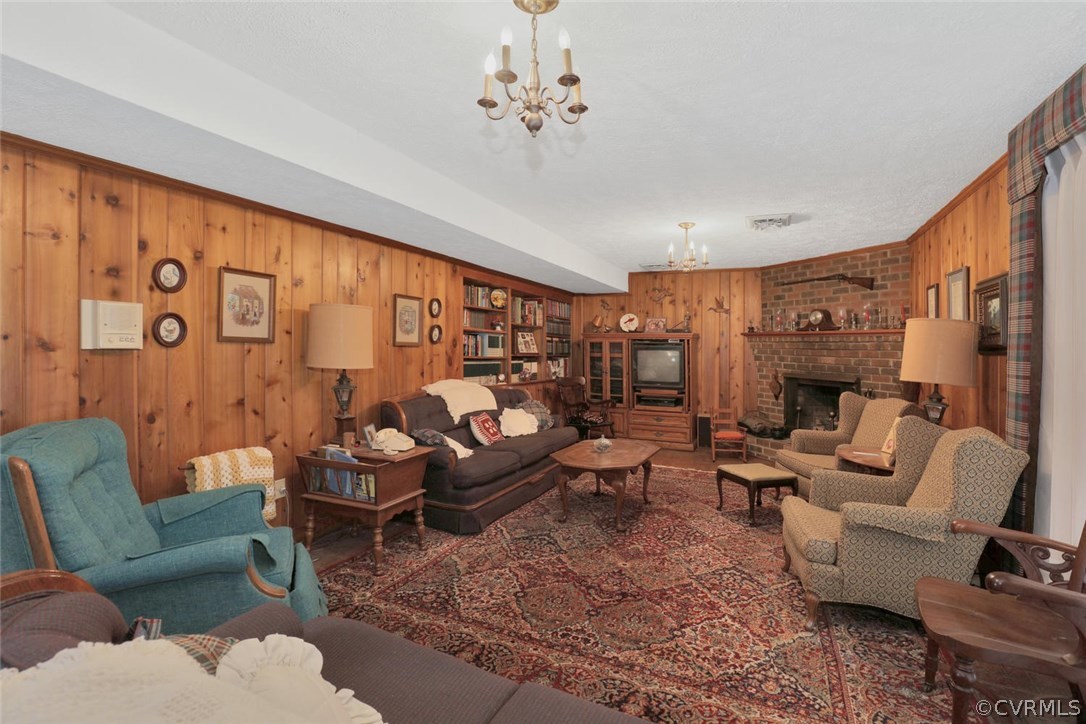 3300 Wood Dale Road Chester, VA 23831 - Photo 20 of 28 a living room with furniture or couch and a chandelier