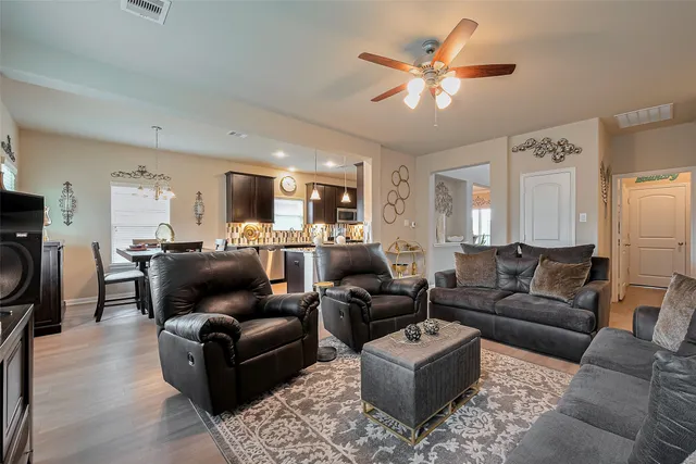 a living room with furniture a fireplace a rug and a window