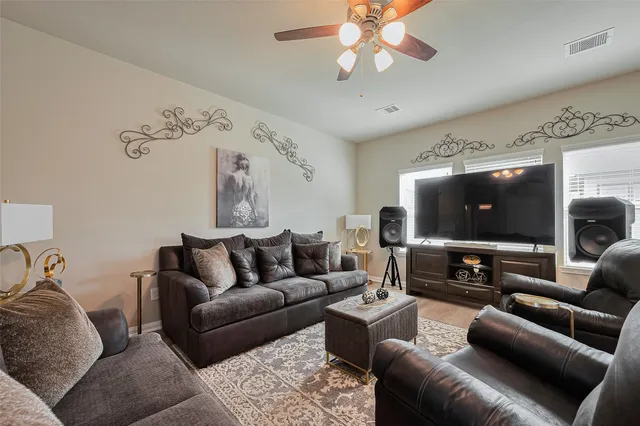a living room with furniture and a flat screen tv