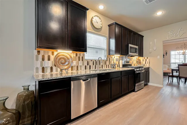 a kitchen with a sink cabinets and window