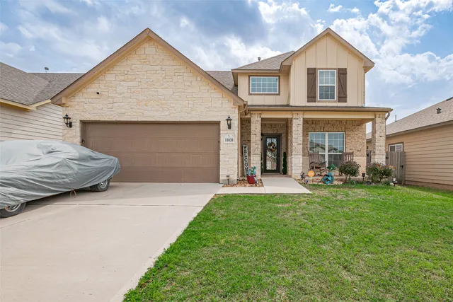 a front view of a house with a yard and porch