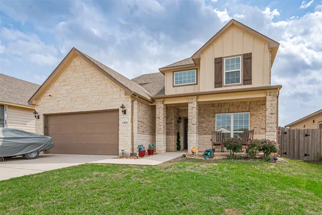 a front view of house with yard and outdoor seating
