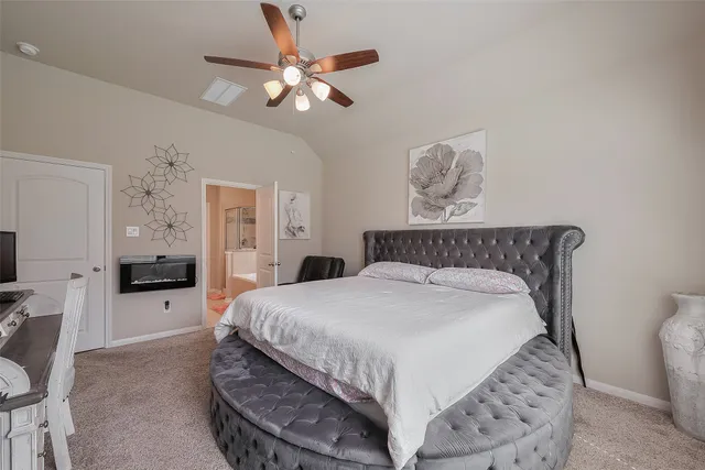 a bedroom with a large bed and a chandelier