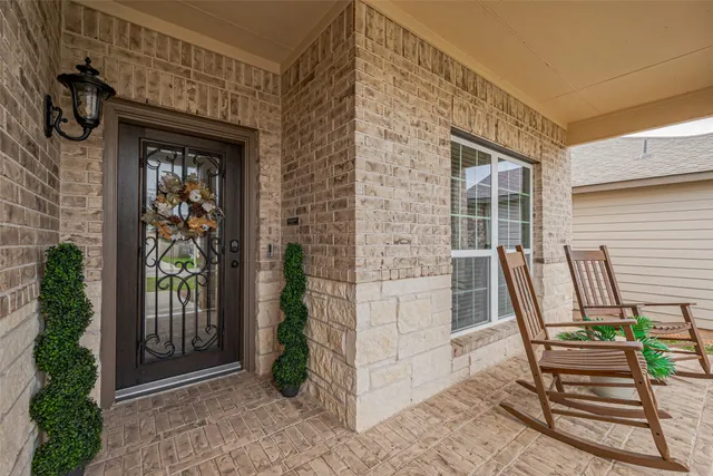 a front view of a house with outdoor seating and stairs