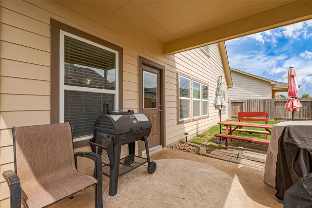 a view of a house with backyard and sitting area