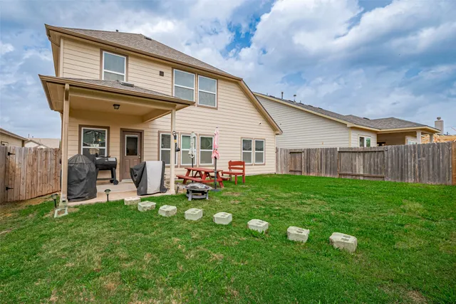 a view of a house with backyard and porch