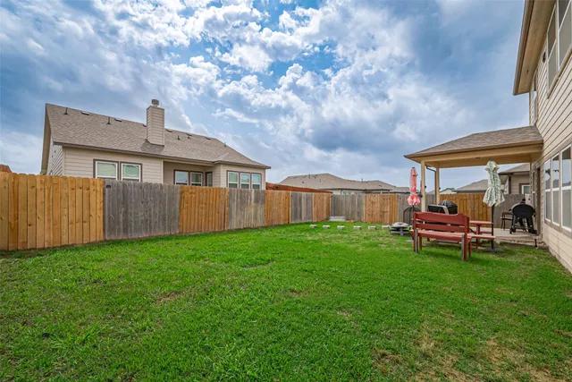 a view of a house with backyard and porch