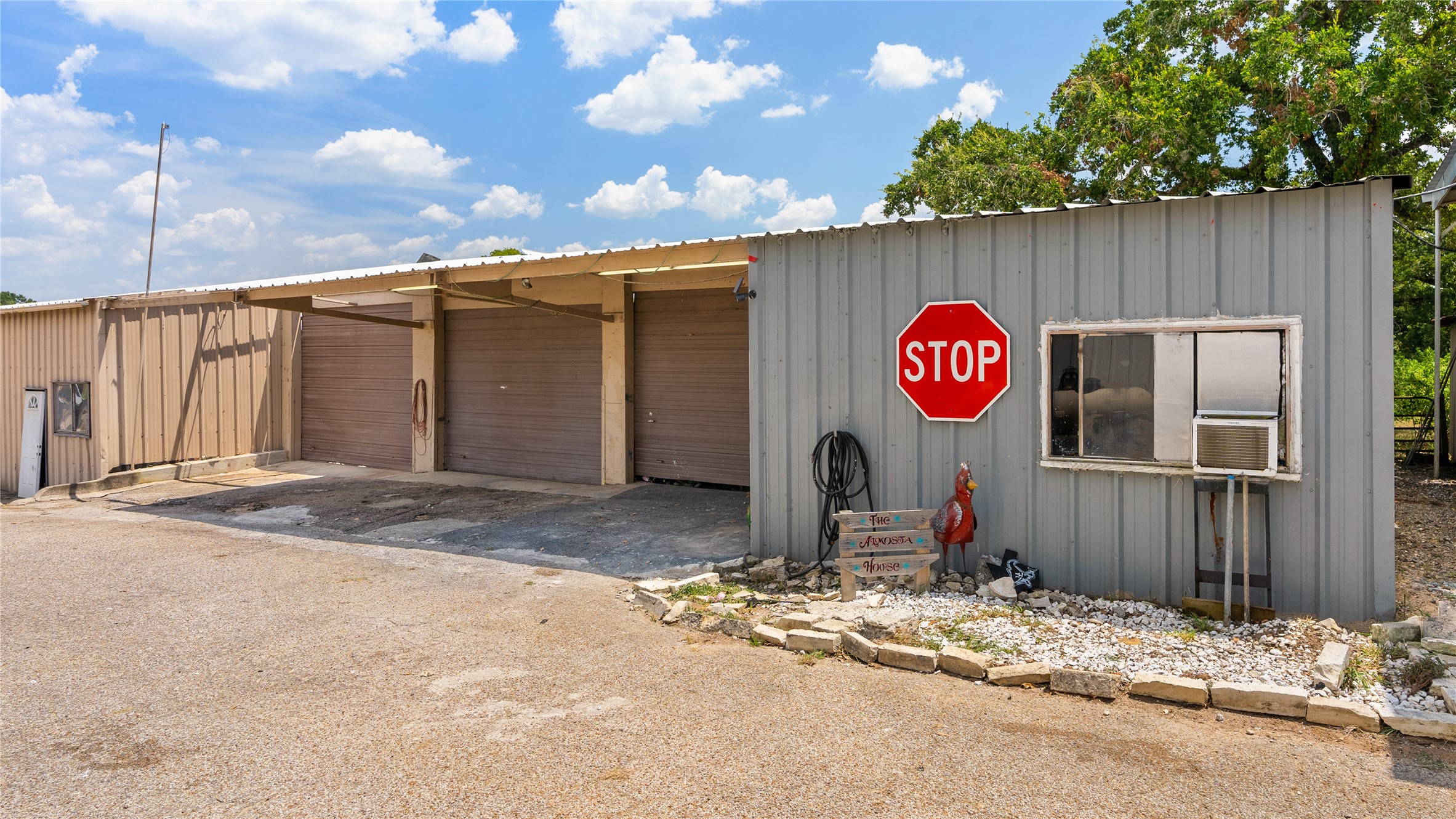 41115 Community Road Magnolia, TX 77354 - Photo 22 of 28 a view of a wooden house next to a road