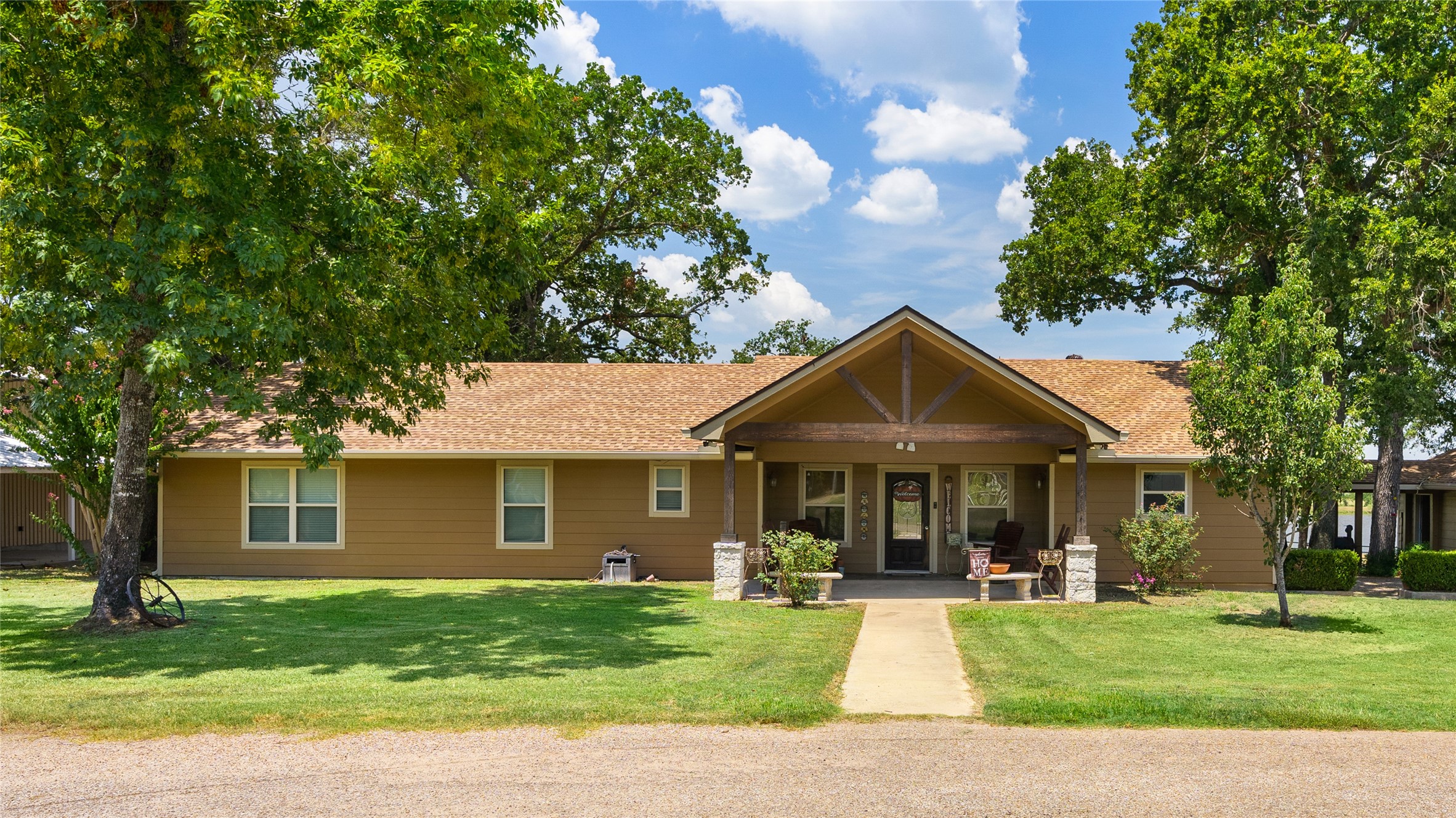41115 Community Road Magnolia, TX 77354 - Photo 4 of 28 a front view of a house with a yard porch and outdoor seating