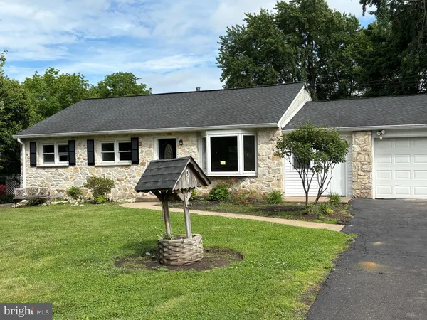 a front view of house with a garden