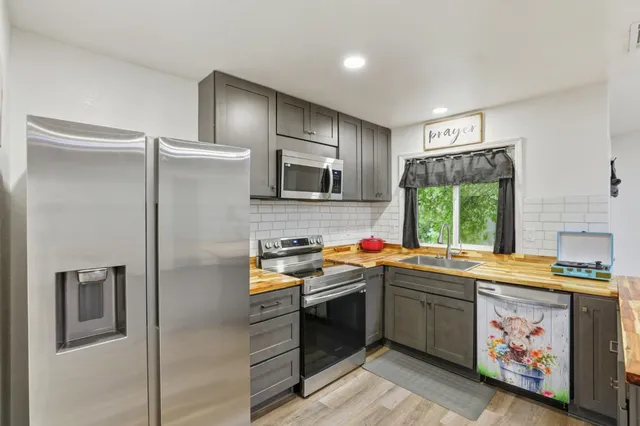 a kitchen with a stove a sink and a microwave