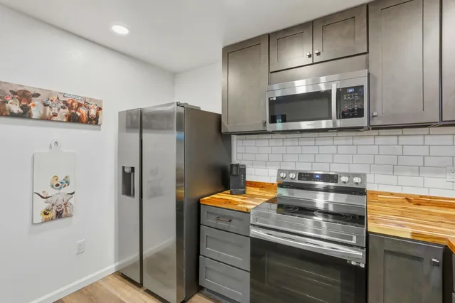 a kitchen with a sink stove and wooden cabinets