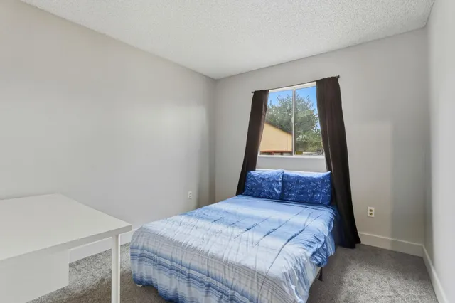 a bedroom with a bed and a dresser