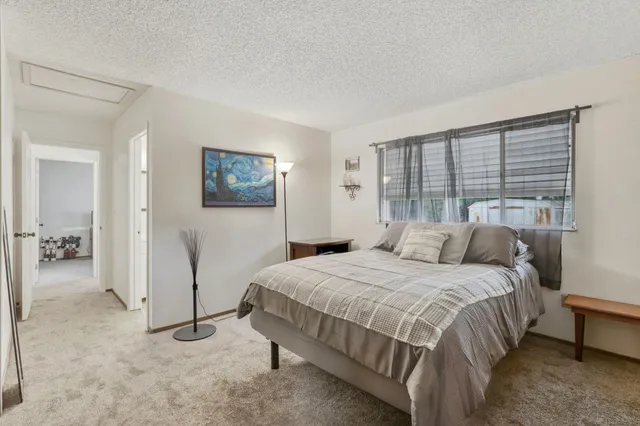 a bedroom with a bed and a view of walk in closet