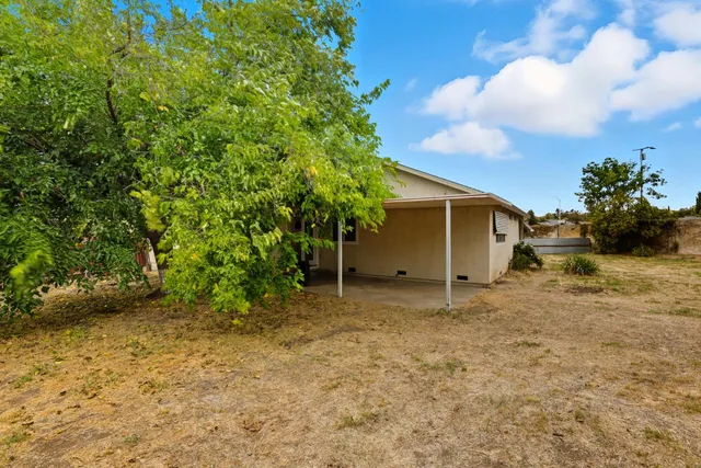 a view of a table and chairs in the backyard