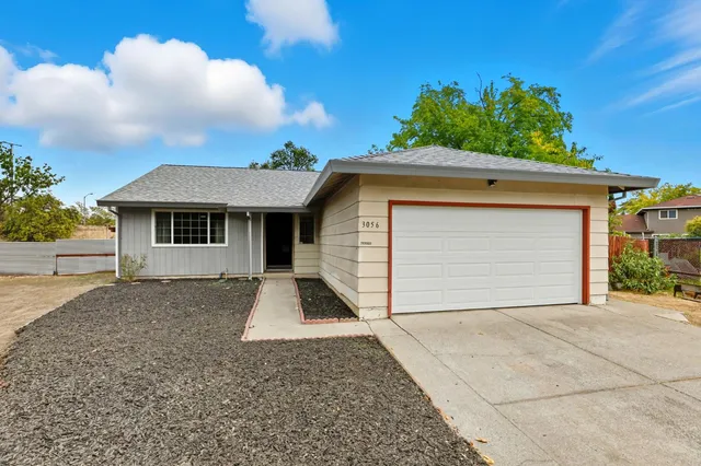 a living room with furniture and a ceiling fan