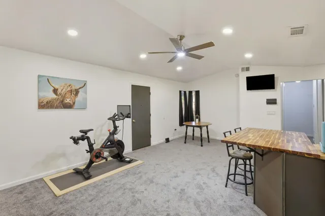 a kitchen with stainless steel appliances granite countertop a stove refrigerator sink and cabinets