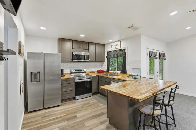 a kitchen with a sink stove and refrigerator