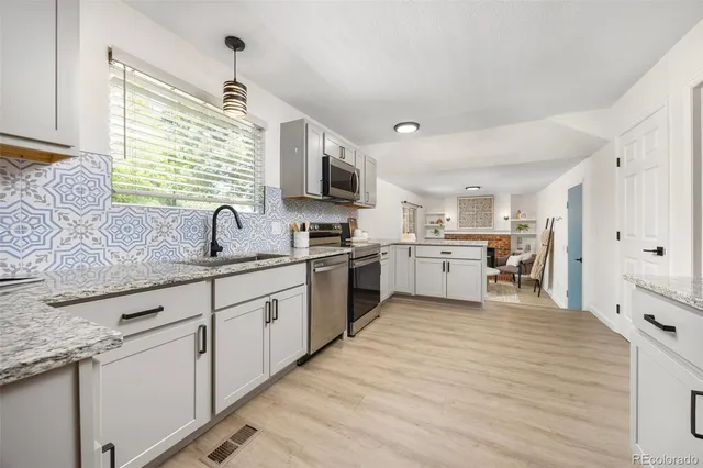 a kitchen with a sink cabinets and window